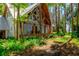 Home with exposed wooden beams, front porch, and lush, tropical landscaping at 20926 Ragan Ln, Land O Lakes, FL 34638