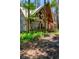 Home with exposed wooden beams, front porch, and lush, tropical landscaping at 20926 Ragan Ln, Land O Lakes, FL 34638