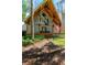 Home with exposed wooden beams, front porch, and lush, tropical landscaping at 20926 Ragan Ln, Land O Lakes, FL 34638