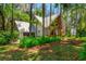 Home featuring a metal roof, a circular window, and a matching detached garage at 20926 Ragan Ln, Land O Lakes, FL 34638
