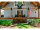 Home with exposed wooden beams and front porch with lovely landscaping at 20926 Ragan Ln, Land O Lakes, FL 34638