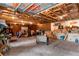 Large detached garage with unfinished ceilings, exposed beams, concrete floor, and room for storage at 20926 Ragan Ln, Land O Lakes, FL 34638
