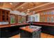 Stylish kitchen with black cabinets, butcher block countertops, and modern lighting fixtures at 20926 Ragan Ln, Land O Lakes, FL 34638