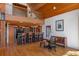 Open kitchen and dining area with wood floors, a bar with stools, and a round dining table at 20926 Ragan Ln, Land O Lakes, FL 34638