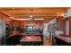 Open concept kitchen with wood beams, stainless steel appliances, and a central island at 20926 Ragan Ln, Land O Lakes, FL 34638