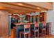 Kitchen with wood bar, wood cabinets, pendant lighting, and three wooden barstools at 20926 Ragan Ln, Land O Lakes, FL 34638