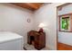 Laundry room featuring a washer and dryer, accented with patterned wallpaper and a wooden ceiling at 20926 Ragan Ln, Land O Lakes, FL 34638