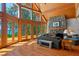Spacious living room featuring a stone fireplace, wood floors and large windows with lake views at 20926 Ragan Ln, Land O Lakes, FL 34638
