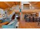 Open-concept living space with vaulted ceilings, hardwood floors, staircase, and a kitchen bar at 20926 Ragan Ln, Land O Lakes, FL 34638