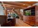 Living room featuring a staircase and entertainment center with a scenic view at 20926 Ragan Ln, Land O Lakes, FL 34638