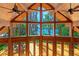 Bright open living area with wooden beamed ceilings, ceiling fans and expansive windows offering scenic views at 20926 Ragan Ln, Land O Lakes, FL 34638