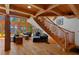 Spacious living room with a stone fireplace, staircase, and views of the lake at 20926 Ragan Ln, Land O Lakes, FL 34638