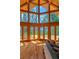 Bright living room with wood floors, soaring ceilings and lake views from multiple windows at 20926 Ragan Ln, Land O Lakes, FL 34638