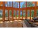 Bright living room with wood floors, soaring ceilings and lake views from multiple windows at 20926 Ragan Ln, Land O Lakes, FL 34638