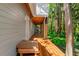 Long wood porch with view of lush trees and underbrush, a great addition to this lakeside home at 20926 Ragan Ln, Land O Lakes, FL 34638