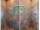 Tile shower with an oval window offering views of the surrounding foliage at 20926 Ragan Ln, Land O Lakes, FL 34638