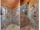 Tiled shower featuring a shower head and stylish fixtures, with a natural wood ceiling at 20926 Ragan Ln, Land O Lakes, FL 34638