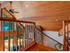 Wooden staircase featuring stone accent wall, natural light and overlooking a view of the outside scenery at 20926 Ragan Ln, Land O Lakes, FL 34638