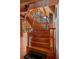 Elegant curved wood staircase with stone accent wall and abundant natural light in this beautiful home at 20926 Ragan Ln, Land O Lakes, FL 34638