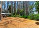Wooden deck area with views of the lake and trees. Enjoy this home's great connection with nature at 20926 Ragan Ln, Land O Lakes, FL 34638