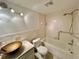 Bathroom with stylish vanity sink, tiled walls, and a tub with shower at 2100 World Parkway Blvd # 50, Clearwater, FL 33763