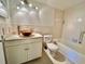 Bathroom with stylish vanity sink, tiled walls, and a tub with shower at 2100 World Parkway Blvd # 50, Clearwater, FL 33763