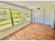 Bright bedroom featuring wood floors, large windows with natural light, and a closet at 2100 World Parkway Blvd # 50, Clearwater, FL 33763