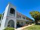 Exterior of condo featuring a well-maintained building, landscape and open balcony at 2100 World Parkway Blvd # 50, Clearwater, FL 33763