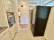 Well-lit kitchen featuring sleek black refrigerator and classic white cabinetry at 2100 World Parkway Blvd # 50, Clearwater, FL 33763