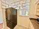 Kitchen featuring stainless steel refrigerator, white cabinets and decorative partition at 2100 World Parkway Blvd # 50, Clearwater, FL 33763