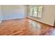 Large living room with wood flooring, white walls and a big window at 2100 World Parkway Blvd # 50, Clearwater, FL 33763