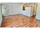 A spacious living room with wood floors, white walls, ceiling fan, and decorative partition at 2100 World Parkway Blvd # 50, Clearwater, FL 33763