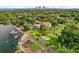 Magnificent aerial view highlighting a waterfront community with docks, lush foliage, and city skyline at 2217 Brevard Ne Rd, St Petersburg, FL 33704