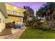 Grassy backyard with stone pavers, a picnic table, and lush landscaping at 2217 Brevard Ne Rd, St Petersburg, FL 33704