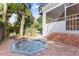 Enjoy this backyard featuring a luxurious hot tub, perfect for unwinding in a serene setting at 2217 Brevard Ne Rd, St Petersburg, FL 33704