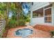 Lush backyard with an inviting hot tub, complemented by mature trees and ample space for relaxation at 2217 Brevard Ne Rd, St Petersburg, FL 33704
