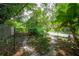 Backyard featuring a brick path surrounded by vibrant greenery and trees at 2217 Brevard Ne Rd, St Petersburg, FL 33704