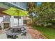 Serene backyard featuring a shaded picnic table and lush landscaping creating a peaceful outdoor space at 2217 Brevard Ne Rd, St Petersburg, FL 33704