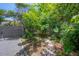 Backyard featuring lush greenery and a brick pathway at 2217 Brevard Ne Rd, St Petersburg, FL 33704