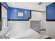 Modern bathroom with blue accent walls, a glass-enclosed shower, and a standalone tub at 2217 Brevard Ne Rd, St Petersburg, FL 33704