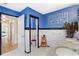 Stylish bathroom featuring custom decor, a double vanity, and adjacent toilet room at 2217 Brevard Ne Rd, St Petersburg, FL 33704