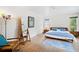 Serene bedroom with hardwood floors, area rug, stylish furniture, and ample natural light at 2217 Brevard Ne Rd, St Petersburg, FL 33704