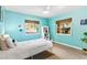 Serene bedroom with cool-toned walls, ceiling fan, and lots of natural light from two windows at 2217 Brevard Ne Rd, St Petersburg, FL 33704