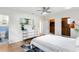 Bright bedroom with ensuite bathroom, closet with wood paneling, and modern ceiling fan at 2217 Brevard Ne Rd, St Petersburg, FL 33704