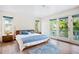 Bright bedroom with hardwood flooring, a comfortable bed, and access to a private balcony at 2217 Brevard Ne Rd, St Petersburg, FL 33704