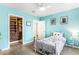 Light blue bedroom features wood-look floors, open closet, and ample natural light at 2217 Brevard Ne Rd, St Petersburg, FL 33704