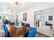 Elegant dining room featuring a large wooden table with blue upholstered chairs and a modern chandelier at 2217 Brevard Ne Rd, St Petersburg, FL 33704