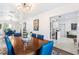 Spacious dining room with a large table, stylish light fixture, and views into the adjacent rooms at 2217 Brevard Ne Rd, St Petersburg, FL 33704
