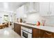 Bright kitchen featuring a vintage oven, white cabinetry, tile backsplash, and stylish decor at 2217 Brevard Ne Rd, St Petersburg, FL 33704