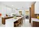 Modern kitchen featuring white cabinets, wood accents, a large island, and stainless steel appliances at 2217 Brevard Ne Rd, St Petersburg, FL 33704